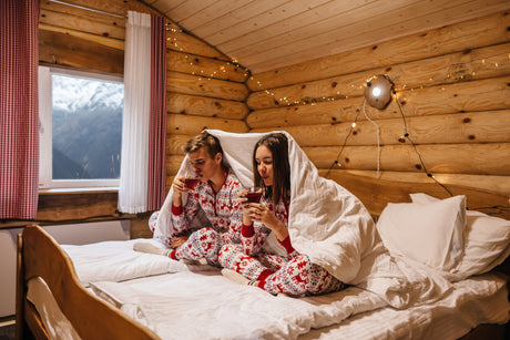 2 people under a warm blanket with snow outside