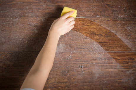 wiping dust off wooden table